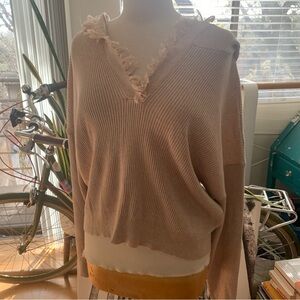 Le Lis v-neck sweater with hoodie and fringe around v-neck and hoodie. Beige/tan